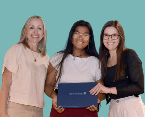 Choir instructor Rachel Stoddard with student Liantosa A. with violin instructor Jamilyn Richardson.