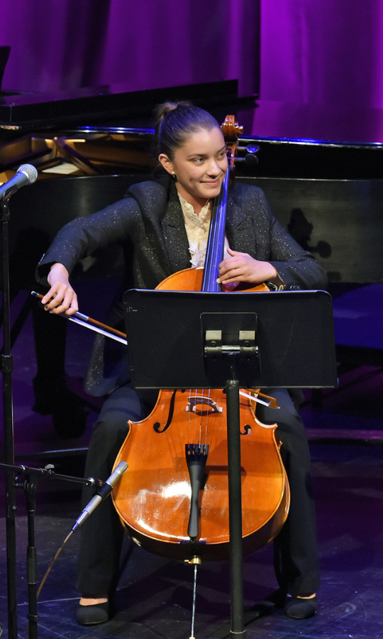 Student playing cello at concert